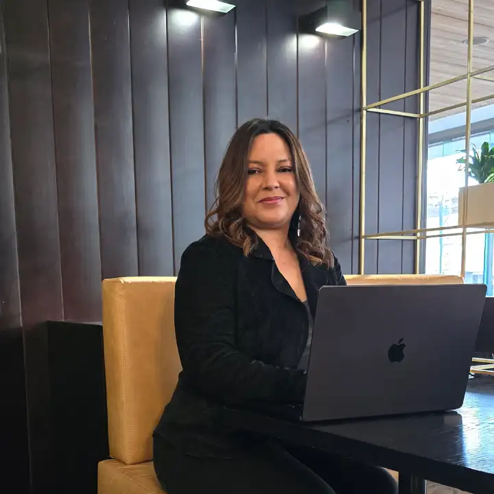René, Founder and Creative Director of Ocean Digital Studio, working on her laptop